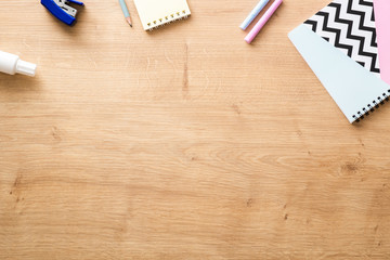 School supplies on wooden desk table background. Back to school concept. Flat lay, top view.