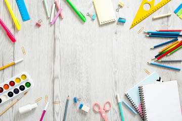 Wall Mural - Back to school concept. Flat lay school supplies on wooden desk table. Frame made of school stationery, copy space, top view. 