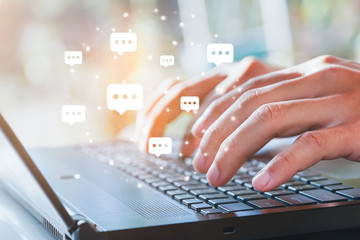 Live chat chatting and social network concepts, Close-up hands typing on keyboard laptop with chat box icons