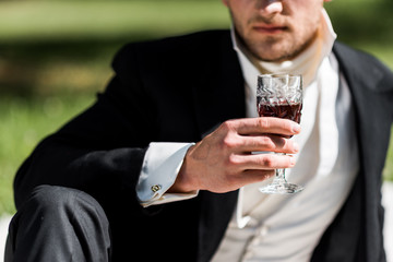 Wall Mural - cropped view of victorian man holding wine glass with drink