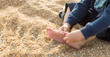 © AAlves - Child playing with the toes and feeling the texture of the beach sand, sensory experience