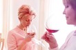 © MDBPIXS - Mature women drinking wine while standing at home