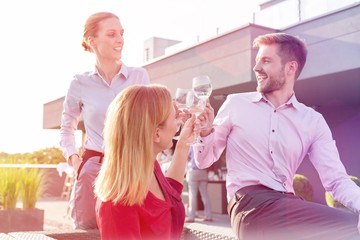 Business people on a rooftop party.