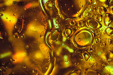Abstract Sunflower Oil Drops on Gold Background.