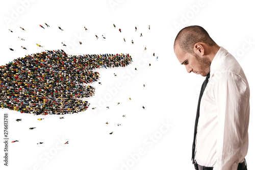 Fotografía Crowd of people united forming a hand pointing a sad man