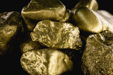 Sticker - gold texture, many gold nugget, stone of value. Crude gold drawn on black background. Concept of wealth or luxury.