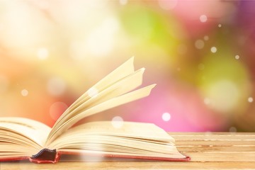 Wall Mural - open book on old wooden table.