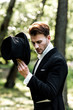 © LIGHTFIELD STUDIOS - handsome aristocratic man holding hat while standing in suit