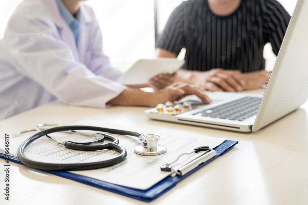 Doctor explaining for patient and showing medical records informations ...