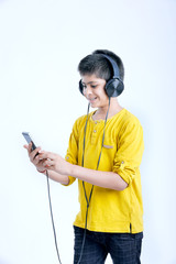 Wall Mural - young indian cute boy listening music in headphone