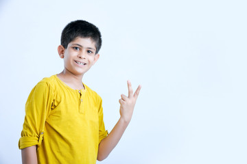 young indian boy showing fingers