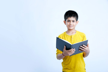 Wall Mural - young indian cute child with book