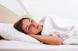 © Alex - A young woman with open eyes is lying in bed. Concept insomnia, dreams, sleeping pills, problems
