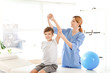 © Pixel-Shot - Physiotherapist working with little boy in rehabilitation center