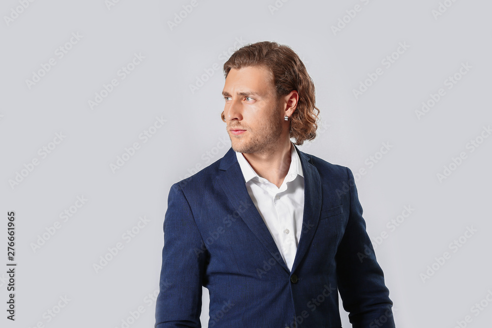 Stylish young man in formal clothes on white background