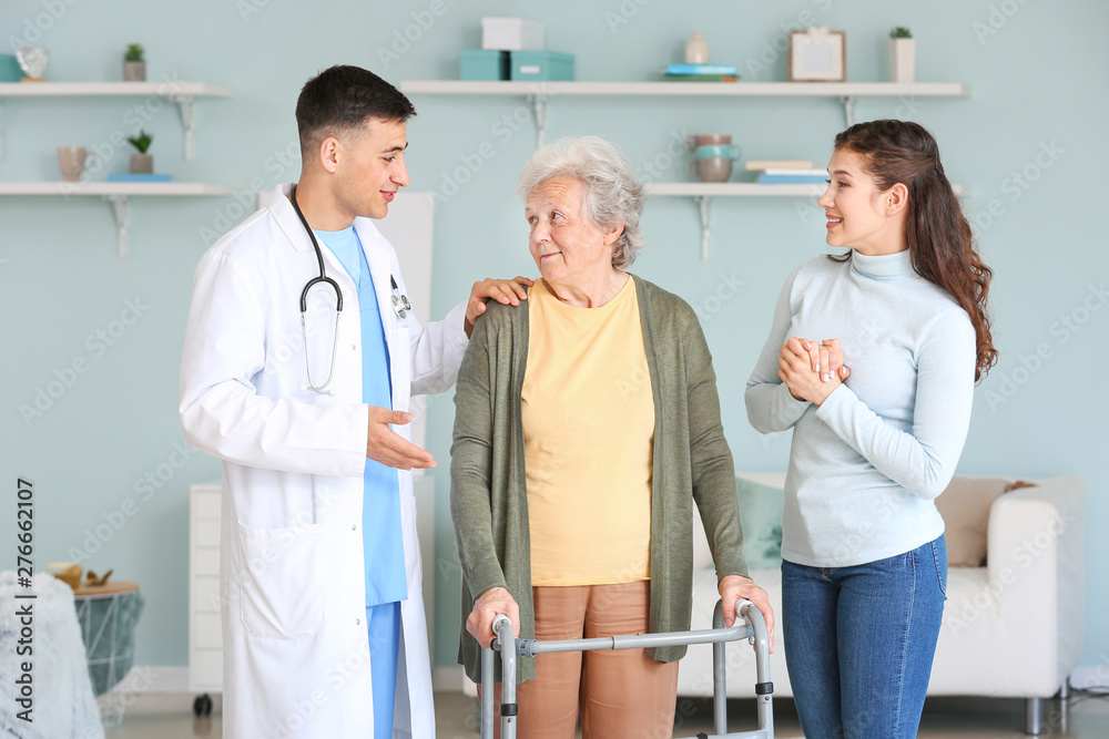 Doctor visiting senior woman at home