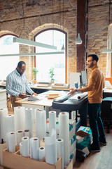 Wall Mural - Bearded man talking to writer while printing his book