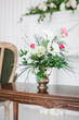 © stock28studio - A bouquet of artificial flowers in a vase in the luxurious interior of the room. Soft focus.