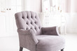 Gray vintage chair in the luxurious interior of the living room. Soft focus.