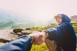 © Amina - Couple Man and Woman holding hands follow enjoying caucasian mountains landscape on background Love and Travel emotions Lifestyle concept. Young family traveling active adventure vacations.