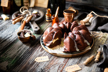 Delicious Homemade Chocolate Bundt Cake On Wooden Plate Stands On Rustic Table