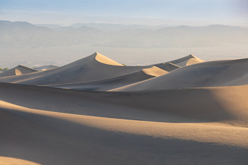 Wall Mural - Early Morning Sunlight Over Sand Dunes And Mountains At Mesquite flat dunes, Death Valley National Park, California USA Stovepipe Wells sand dunes, very nice structures in sand Beautiful background