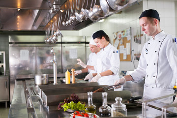 Wall Mural - the work of the cook in the kitchen of the restaurant.