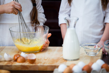 two girls make flour dough.