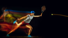 One Caucasian Woman Playing Tennis Isolated On Black Background In Mixed And Stobe Light. Fit Young Female Player In Motion Or Action During Sport Game. Concept Of Movement, Sport, Healthy Lifestyle.