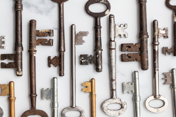 Wall Mural - Large set of vintage keys on a plain background. Safety and security concept