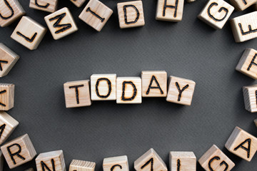 Fototapete - the word today wooden cubes with burnt letters, gray background top view, scattered cubes around random letters