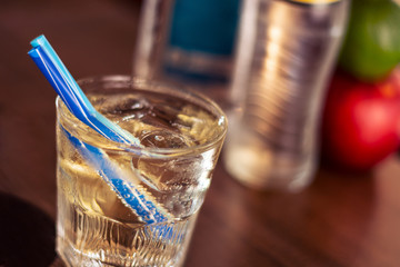 alkohol drink with blue straw on the table