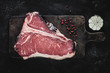 Premium Dry Aged Raw T-bone Steak on Rustic Kitchen Chopping Board