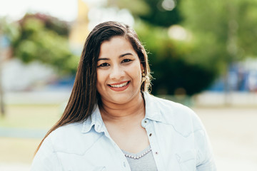 portrait of beautiful plus size woman in the park