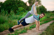 © Svetlana - father and daughter do acrobatic exercises on the background of nature