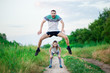© Svetlana - Sport family portrait of handsome father and his cute little daughter play leap frog outdoor at sunset