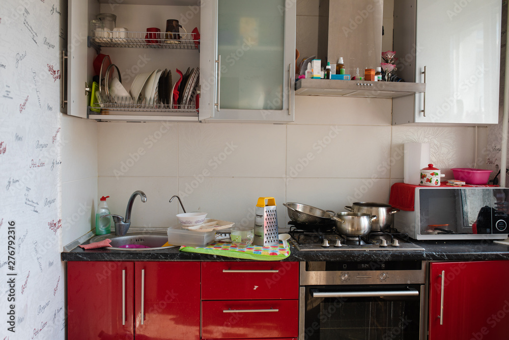 Typical small kitchen with dirty dishes and clutter full shot ...
