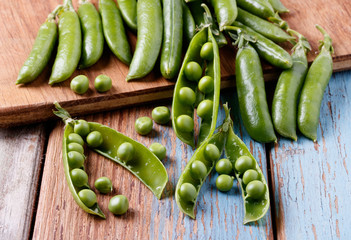 heap of green peas on a wooden table