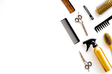 Poster - Combs, spray and hairdresser tools in beauty salon work desk on white background top view mockup