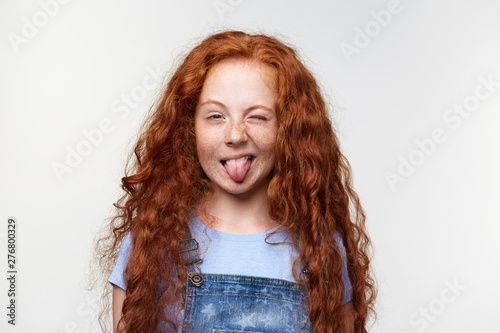 Close Up Of Funny Nice Little Girl With Ginger Hair And