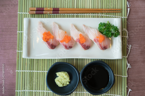 Hamachi Sushi On White Plate Along With Japanese Sauce And
