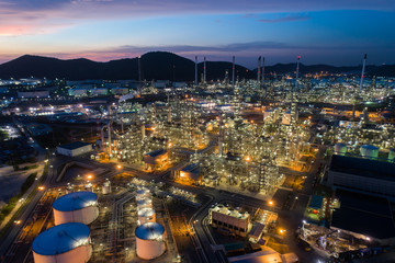 Aerial view oil storage tank with oil refinery factory industrial. Oil refinery plant at night. industry factory concept and transportation.