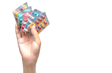 Wall Mural - Hand holding pack of antibiotic capsule pills isolated on white background. Giving or receiving drug. Antibiotic drug overuse. Antimicrobial drug resistance. Pharmaceutical product. Healthcare.