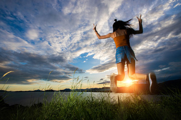 Open World Sky with wind Cloud over sunset red ray beam to adult asian woman long black hair skinny vast who feel lonely happy success to stand on top of clip ocean sight view, copy space low exposure