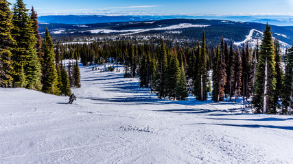 Spring skiing in the High Alpine on the Hills surrounding the Alpine Village of Sun Peaks in the Shuswap Highlands of central British Columbia, Canada