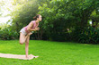 © olga pink - Girl doing yoga on open air on natural meadow