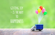 Giving Joy Is The Way To Happiness - Inspiration Motivation Quote. Colorful Air Balloons And Truck Toy On Wood Background. Concept For Visualization Of Delivery Services, Logistics, Business, Travel