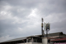 Communication Towers Or Electronics Transmitters On The Roof Of Building. Telecommunications Pole In Urban City  Signal Failure From The Storm Concept.