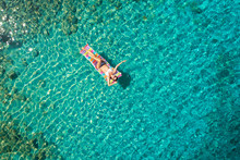 Turquoise Ocean Water And Relaxed Swimming Woman, Aerial Drone Shot.