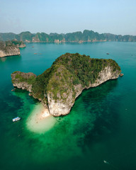 Aerial drone shot over Ha Long Bay, blue sea and limestone islands of Lan ha bay. Vietnam